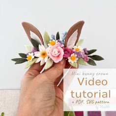 a hand holding a fake flower with the words video tutor on it in front of them