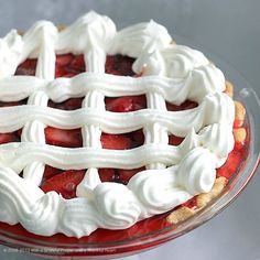 a pie with white icing and strawberries on top