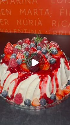 a fruit covered cake sitting on top of a table