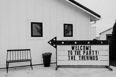 a black and white photo of a welcome sign in front of a building that says, welcome to the party i'm the trevinos