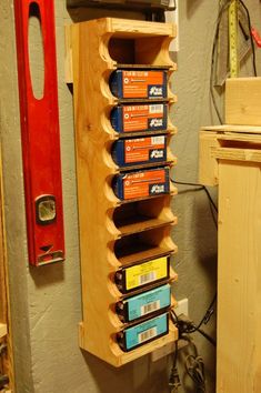 a wooden shelf with many different types of items on it and a ruler next to it