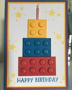 a birthday card made with lego blocks and a lit candle on top of the cake