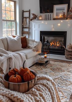 a living room filled with furniture and a fire place next to a couch in front of a fireplace