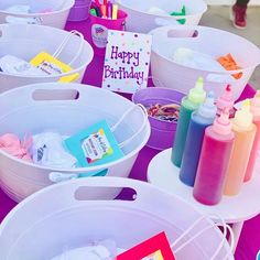 there are many buckets that have items in them on the table with happy birthday cards