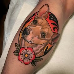 a person with a tattoo on their arm has a dog and flower in the center