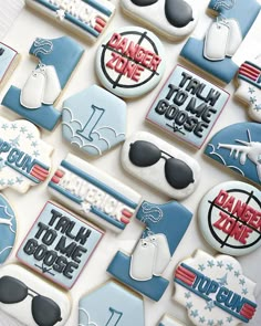 decorated cookies are arranged in the shape of american flags and sunglasses with words that read danger zone, talk to me choose