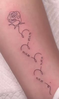 a woman's arm with the names of three different people and a rose on it