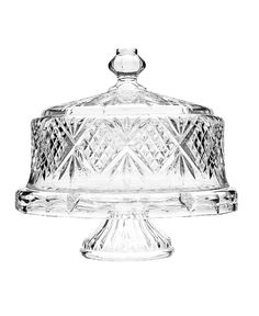 a clear glass cake dish on a white background