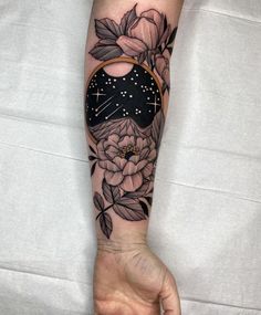 a person's arm with a flower and star tattoo on the left side of their arm