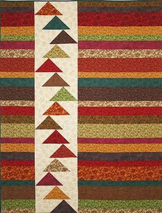 a multicolored striped area rug with an arrow design