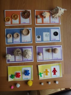 a table topped with cards and toys on top of a wooden table covered in magnets