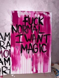 a painting with words written on it in black and pink ink, against a purple background