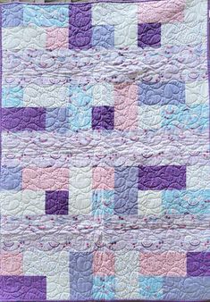 a purple and blue quilt with squares on it