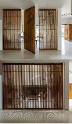 an open door in the middle of a room that has wooden screens on it, and two