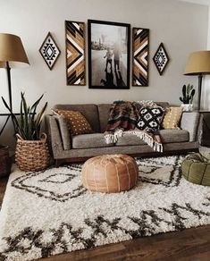 a living room filled with lots of furniture and pictures on the wall above it's couch