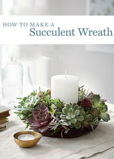 a candle and some succulents in a bowl on top of a table