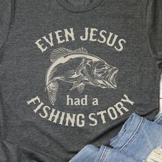 THE STORY "Celebrate Faith and Fishing with Our 'Even Jesus Had a Fishing Story' Shirt!" Combine your love for fishing and your faith with a shirt that highlights the timeless connection between the two. The "Even Jesus Had a Fishing Story" shirt is perfect for those who enjoy casting lines and sharing stories, all while celebrating their spiritual journey. THE FIT True-to-fit. If you prefer a looser fit, we recommend ordering one size larger than normal. SPECS "Printed on Bella Canvas short-sle Fishing Outfits For Women Summer, Warrior Training, Green Font, Funny Fishing Shirts, Gifts For Pastors, Shirts Ideas, Fishing Humor, Fishing Outfits, Fishing T Shirts