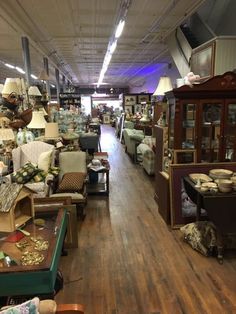 the inside of a furniture store with lots of chairs and couches in front of them