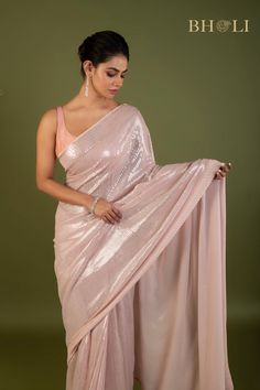 Expertly crafted with high quality Georgette fabric, this partywear saree is designed to make a statement. The elegant pink color and delicate sequin embellishments add a touch of glam to any occasion. Shine bright while feeling comfortable and confident in this must-have saree. Fancy Indian Outfits, Sparkle Saree, Elegant Saree For Farewell, Pink Sequin Saree, Farewell Saree, Diwali Fashion, Indian Fits, Partywear Sarees, Farewell Sarees