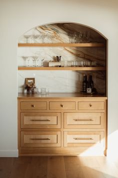 a wooden cabinet with wine glasses on it