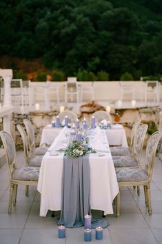 the table is set with white and blue linens