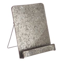 an old metal plate with a stand on it's side, isolated against a white background