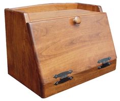 a wooden box with two metal handles on the front and bottom, sitting upright against a white background