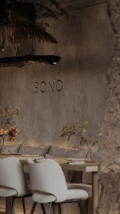 there are four chairs at the table in front of the wall that says sono