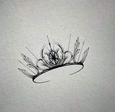 a black and white drawing of a tiara with feathers on it's head