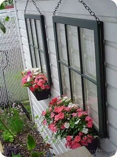 two hanging flower pots on the side of a house