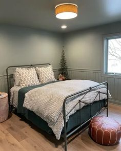 a bedroom with gray walls and wooden floors