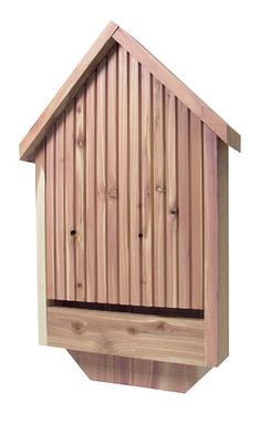 a wooden birdhouse with the roof made out of wood