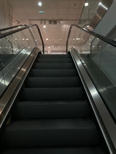 an escalator with two sets of stairs leading up to the second floor