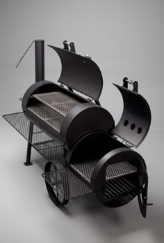 a black bbq grill sitting on top of a white table next to a gray wall