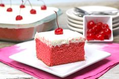 a piece of red velvet cake with cherries on top sits on a plate next to the rest of the cake