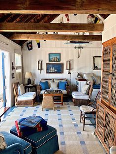 a living room filled with furniture and lots of windows