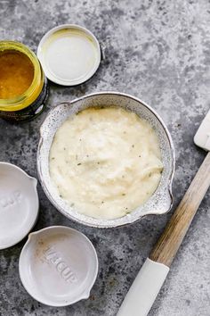 an image of some food that is in the bowl on the table with utensils