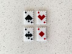 four pieces of plastic beaded playing cards on a white counter top with speckles