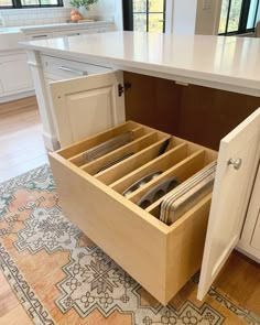 an open drawer in the middle of a kitchen