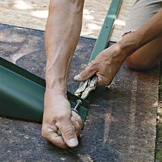 a man is working on something with his hands and feet in front of the ground