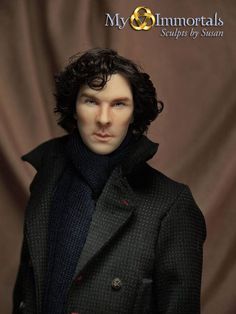 a man with curly hair wearing a black coat and turtle neck sweater in front of a brown background