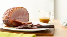 a ham on a plate with knife and fork