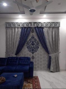 a living room with blue couches and curtains