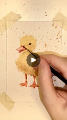 a person is painting a duck with watercolors on paper and then using a marker