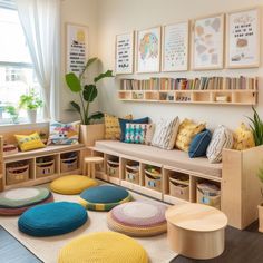 a living room filled with lots of furniture and pillows on top of a wooden floor