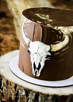 a close up of a cake on a plate with a bull's head painted on it