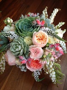 a bouquet of flowers sitting on top of a wooden floor