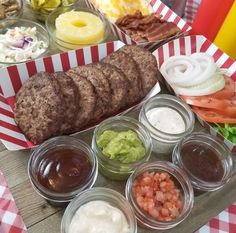 an assortment of food is displayed on a tray with red and white checkered tablecloth