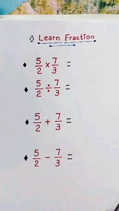 a piece of paper with numbers and fractions written in red on the top, next to a calculator