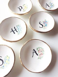 six personalized dishes with floral designs on them